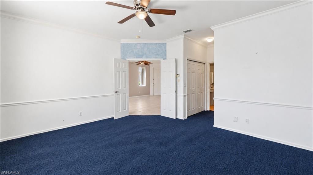 7737 Haverhill Court Naples, FL 34104 - Photo 17 of 37 Spacious interior room featuring plush blue carpeting and white walls with chair rail molding