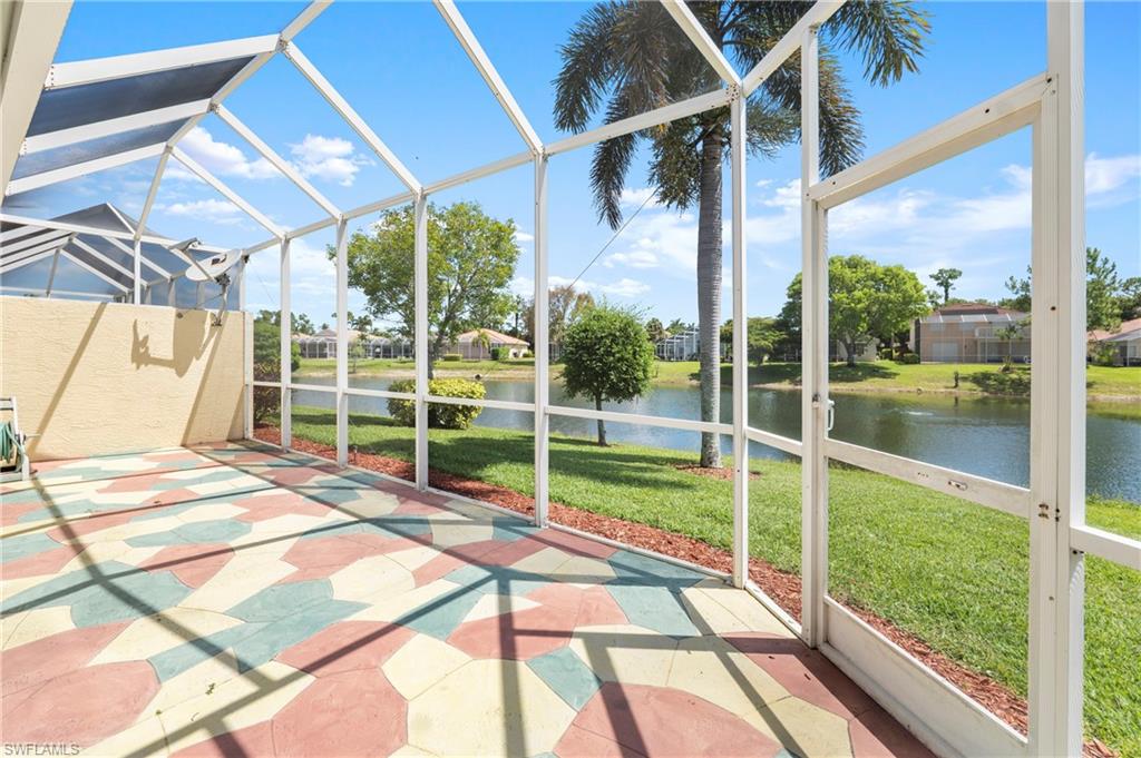 7737 Haverhill Court Naples, FL 34104 - Photo 28 of 37 Screened lanai featuring patterned paver flooring and direct water frontage