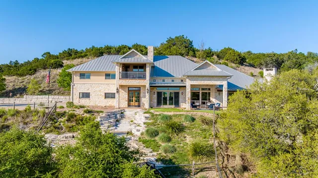 a bed sitting in a bedroom next to a lamp