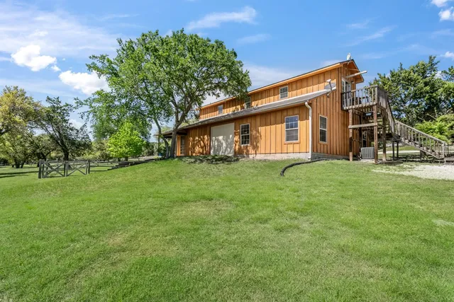 a view of a house with backyard porch and sitting area