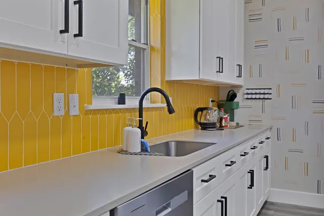 a kitchen with cabinets and window