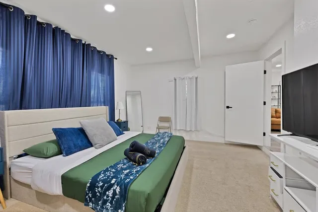 a living room with furniture window and a flat screen tv