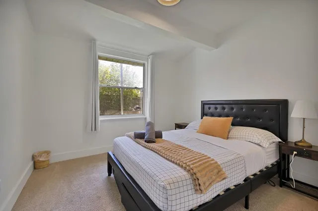 a bedroom with a bed and window