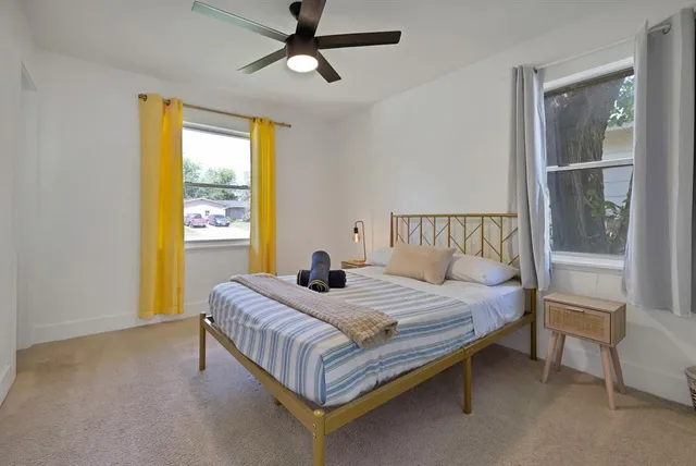 a bedroom with a bed lamp and a window
