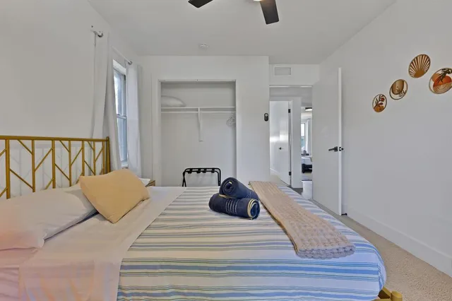 a bedroom with a bed and a couch