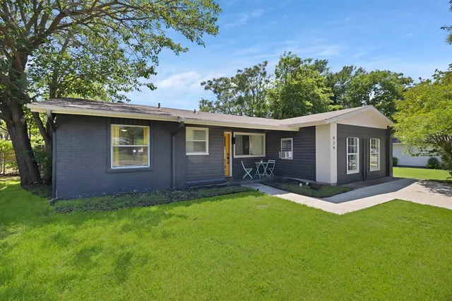 a front view of a house with yard porch and green space