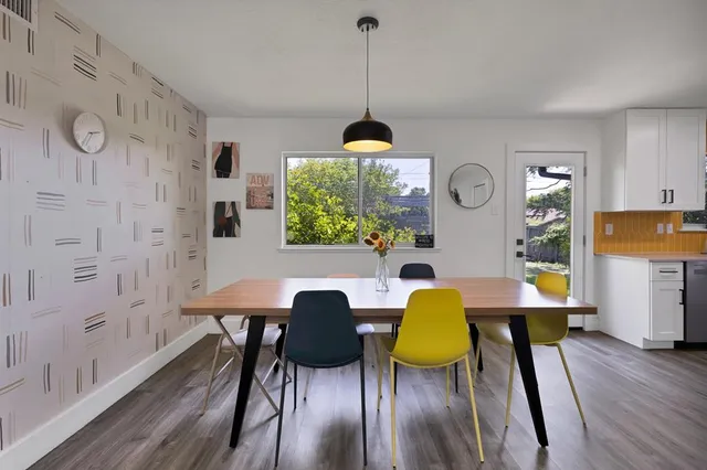 a dining room with furniture and a chandelier