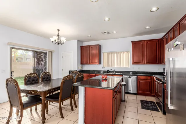 a kitchen with a counter space a sink refrigerator and cabinets