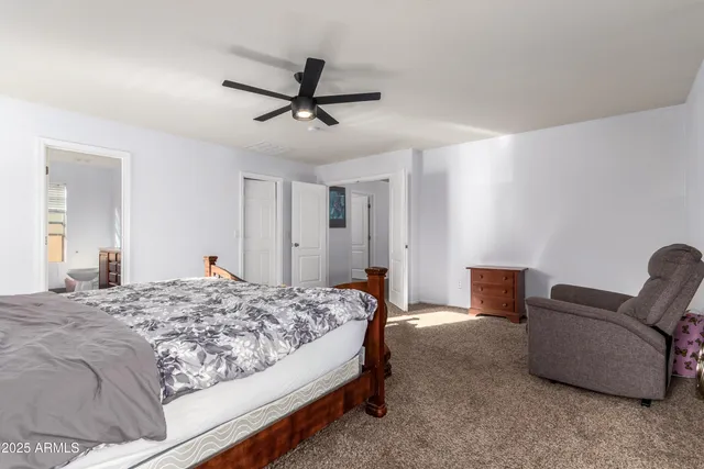 a bathroom with a double vanity sink toilet and a mirror