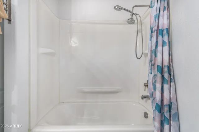 a bedroom that has a bed and a chandelier