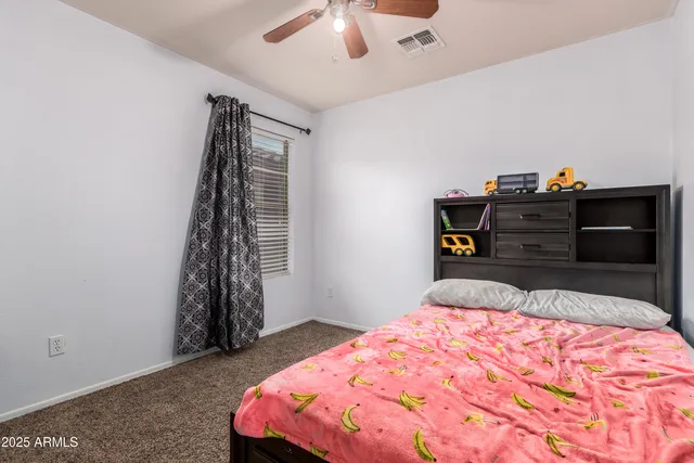 a bedroom with a bed and cabinets