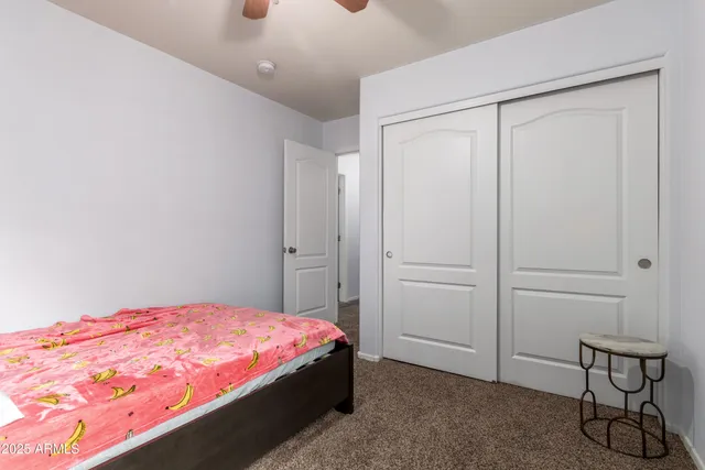 a living room with furniture a piano and a flat screen tv