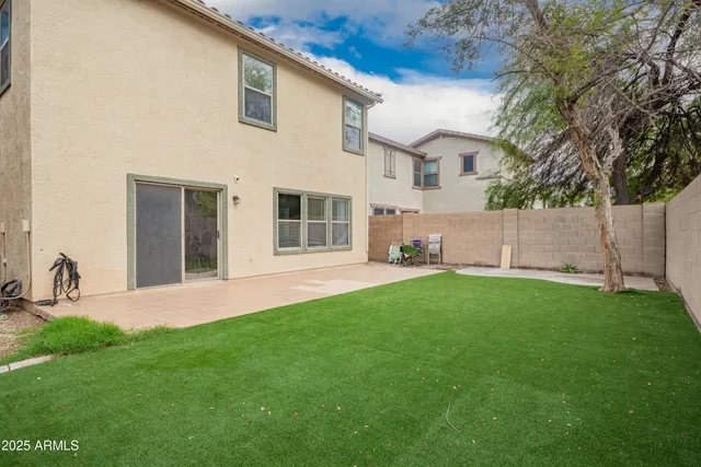 a swimming pool with outdoor seating and yard
