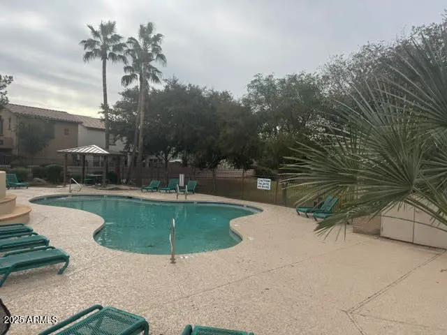 a view of a swimming pool with outdoor seating and plants