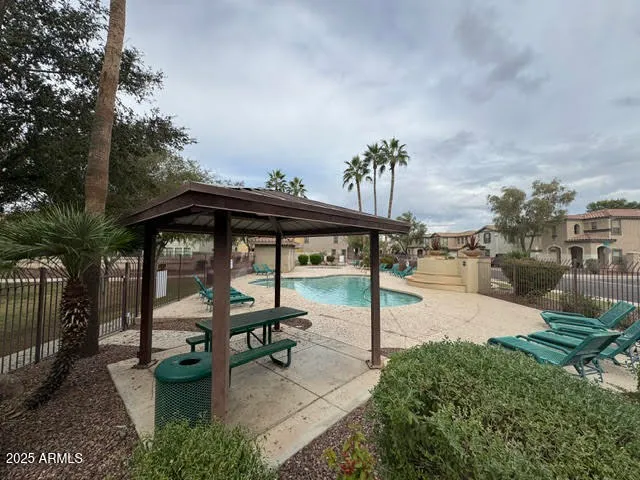 a view of a yard with flower plants and palm trees
