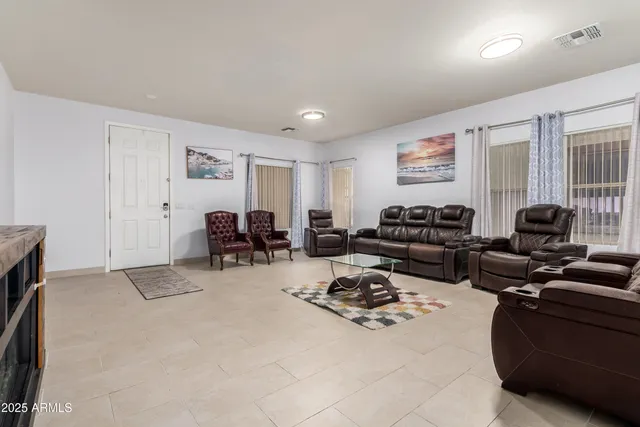 a living room with furniture a couch and a window