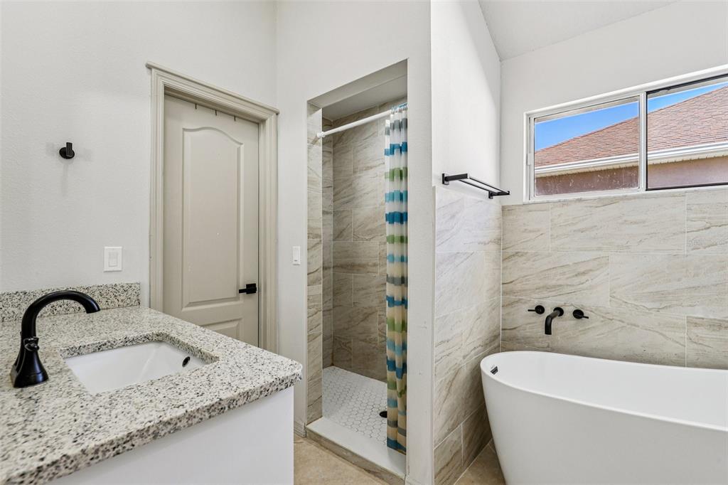 5 Watkins Place Palm Coast, FL 32164 - Photo 12 of 25 a bathroom with a granite countertop sink and a tub