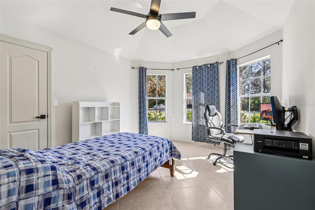 5 Watkins Place Palm Coast, FL 32164 - Photo 13 of 25 a bedroom with a bed mirror and window