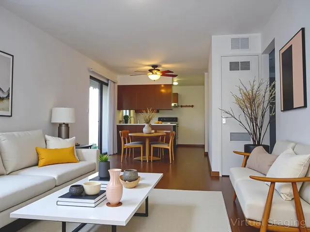 a living room with furniture a rug and a lamp