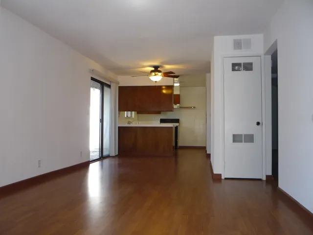 a view of a kitchen with a sink and a refrigerator