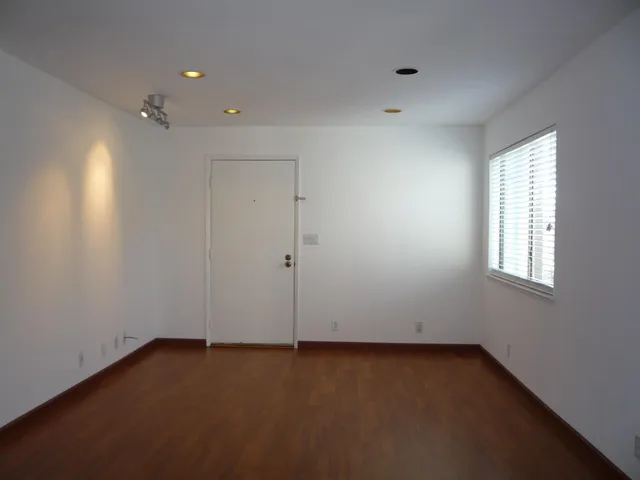 an empty room with a empty space and windows