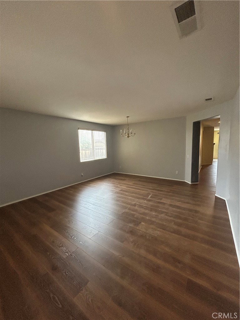 12673 Field Way Victorville, CA 92395 - Photo 4 of 15 an empty room with wooden floor and windows