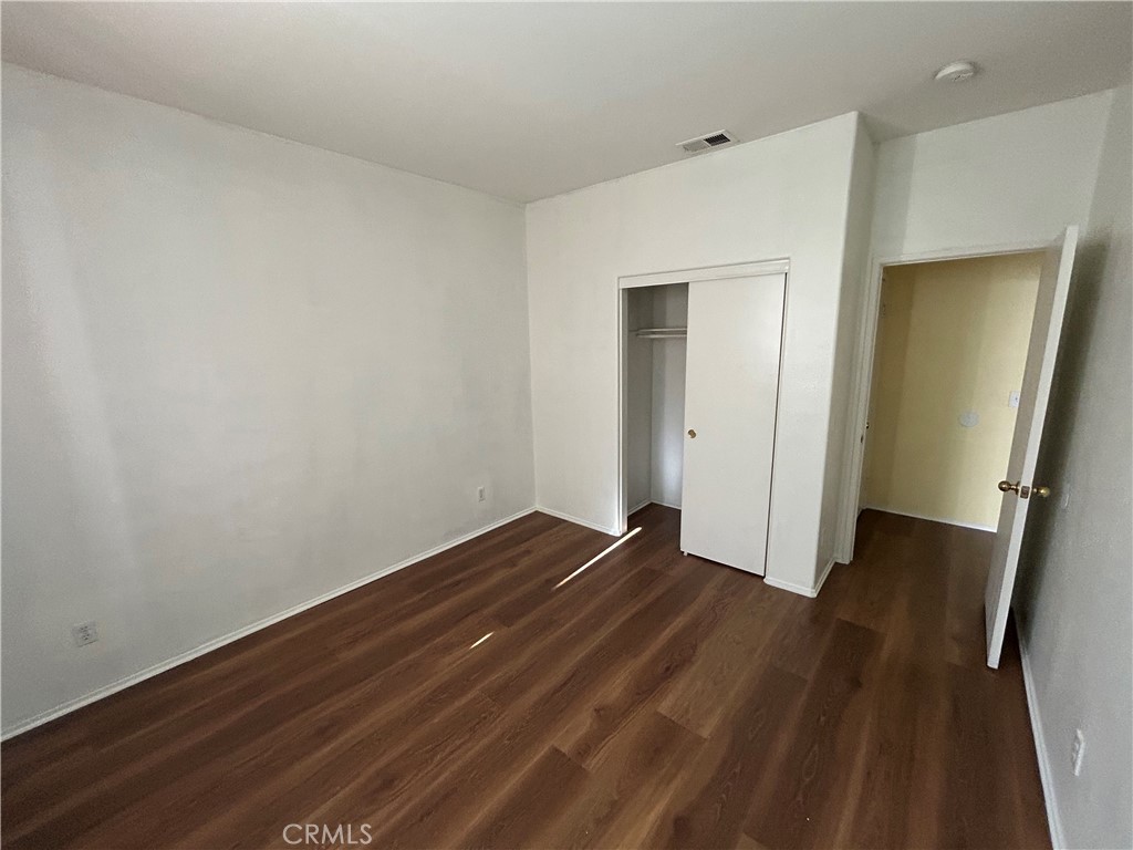 12673 Field Way Victorville, CA 92395 - Photo 9 of 15 a view of an empty room with wooden floor and closet