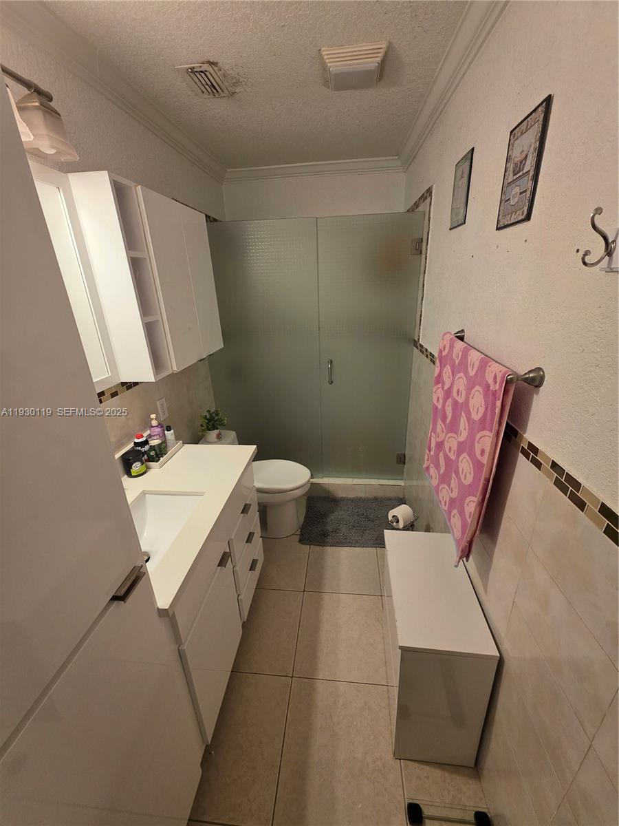 3600 East 5th Avenue Hialeah, FL 33013 - Photo 11 of 13 a bathroom with a toilet sink and mirror