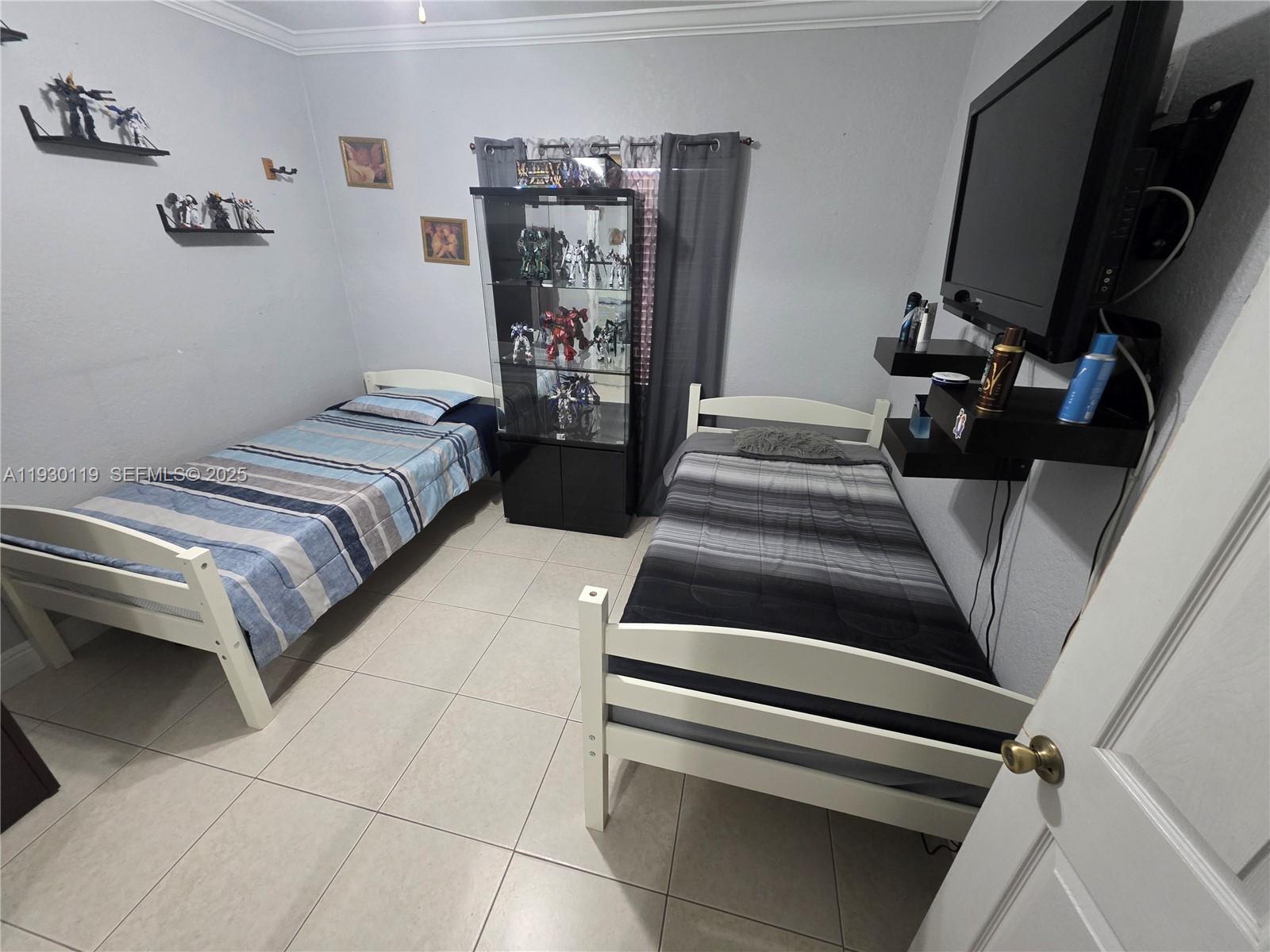 3600 East 5th Avenue Hialeah, FL 33013 - Photo 12 of 13 a bedroom with a bed and a walk in closet