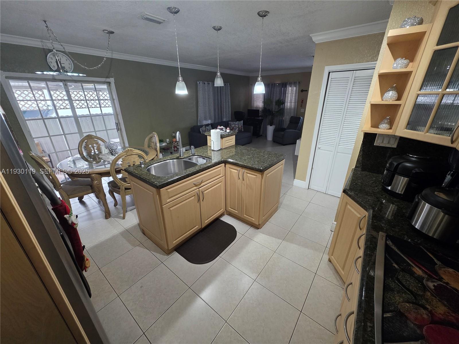 3600 East 5th Avenue Hialeah, FL 33013 - Photo 8 of 13 a kitchen with a sink appliances and cabinets