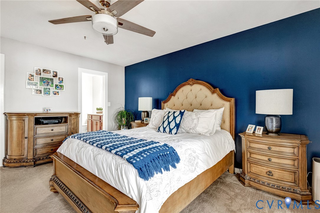 102 Water Pointe Court Midlothian, VA 23112 - Photo 23 of 35 a bedroom with a bed and a chandelier