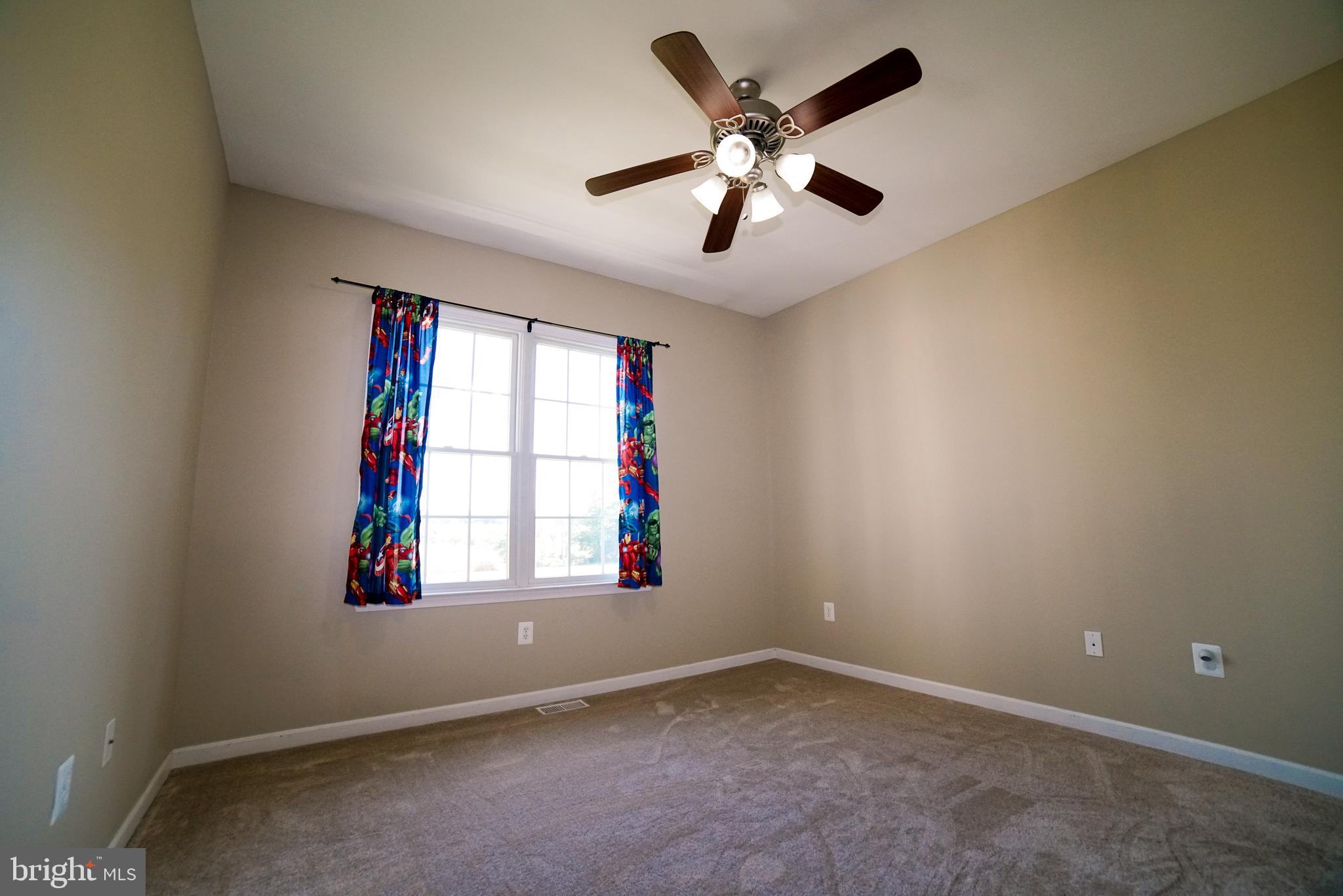 125 South Clear Ridge Road Union Bridge, MD 21791 - Photo 22 of 25 en empty room with windows and ceiling fan