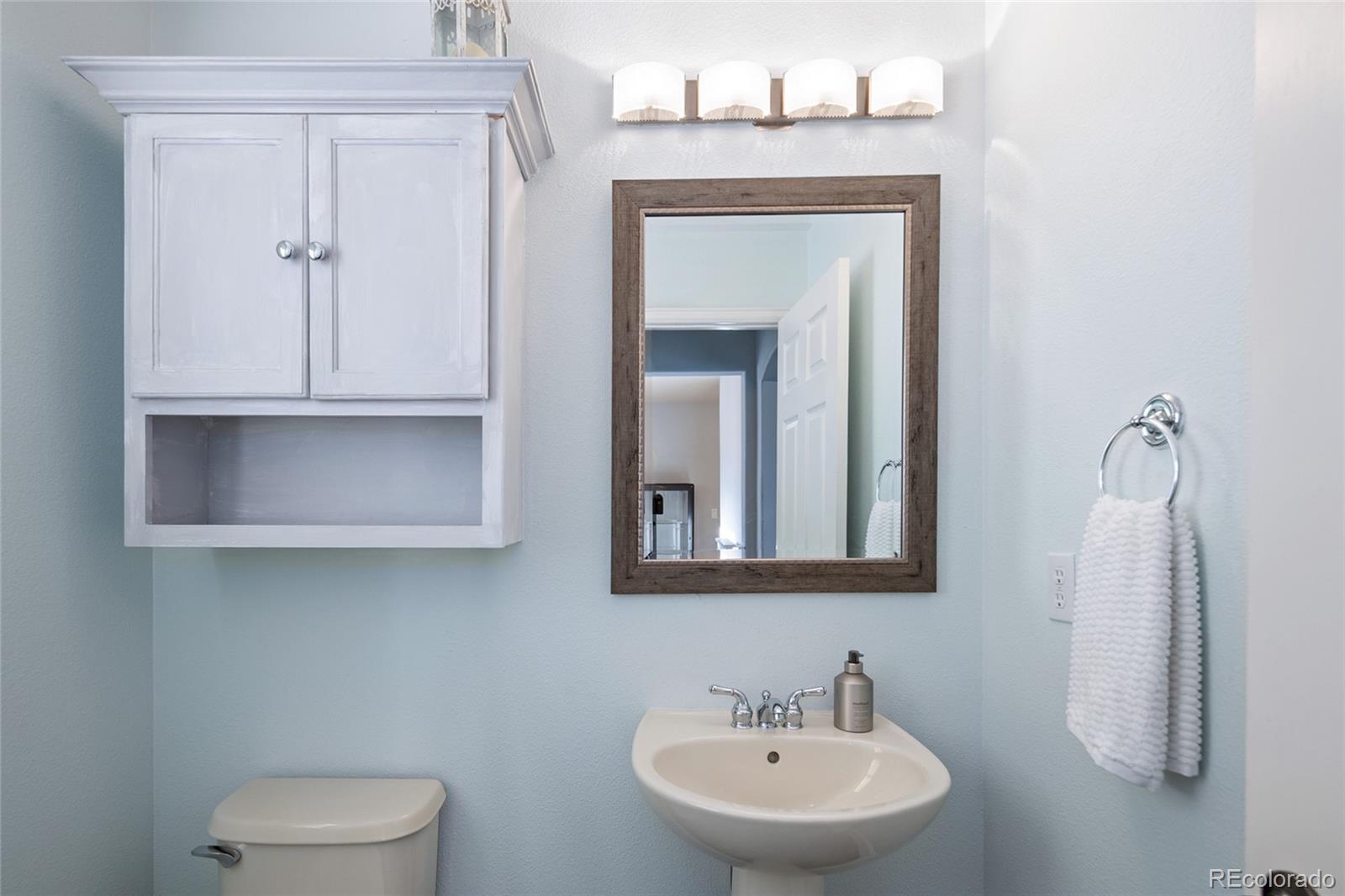 10269 Fawnbrook Court Highlands Ranch, CO 80130 - Photo 11 of 45 a bathroom with a toilet sink and mirror