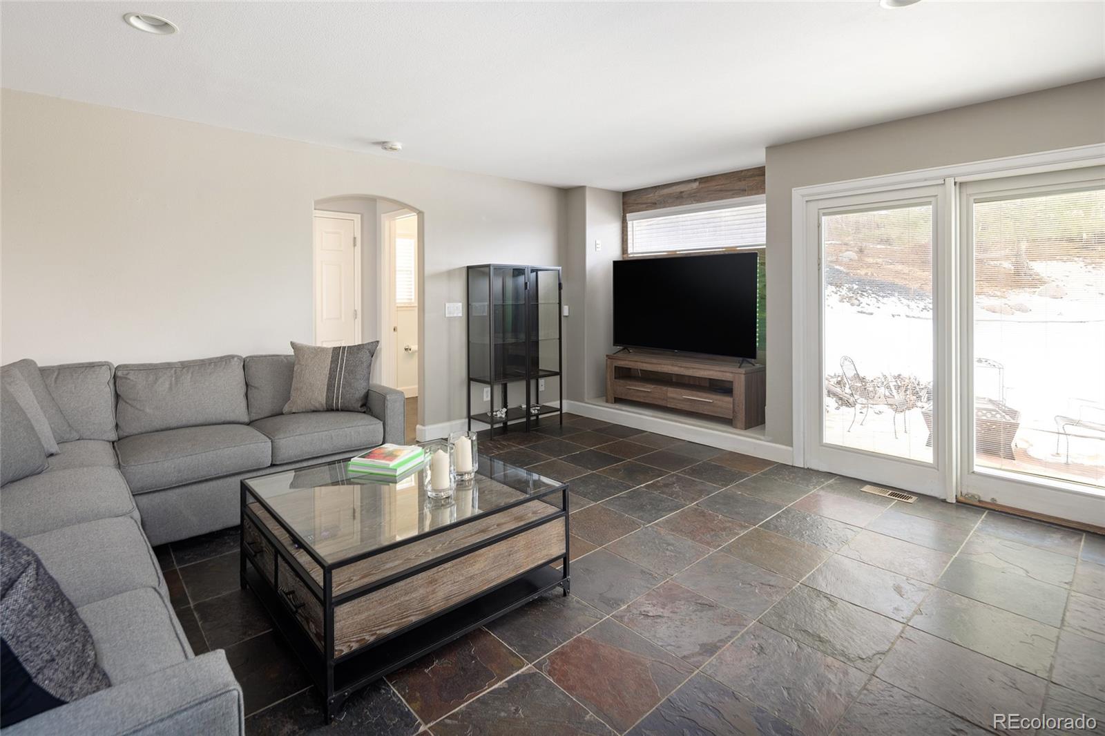 10269 Fawnbrook Court Highlands Ranch, CO 80130 - Photo 17 of 45 a living room with furniture and a flat screen tv