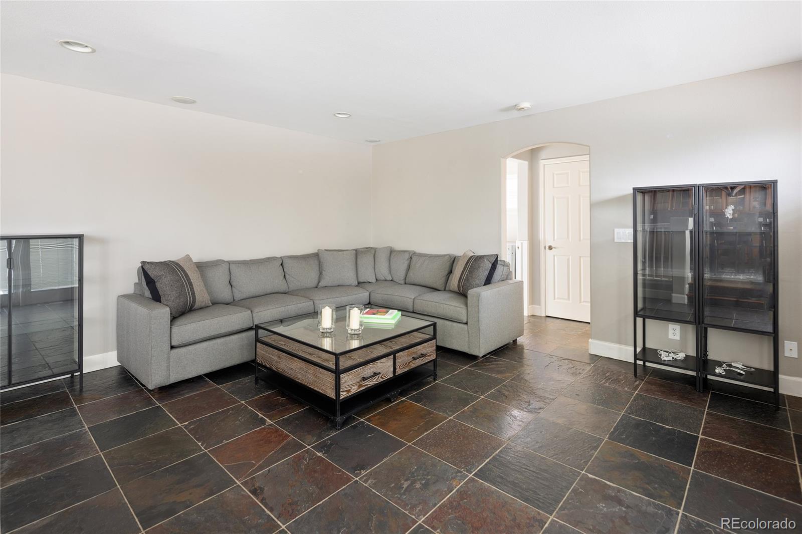10269 Fawnbrook Court Highlands Ranch, CO 80130 - Photo 18 of 45 a living room with a couch and a glass door shower