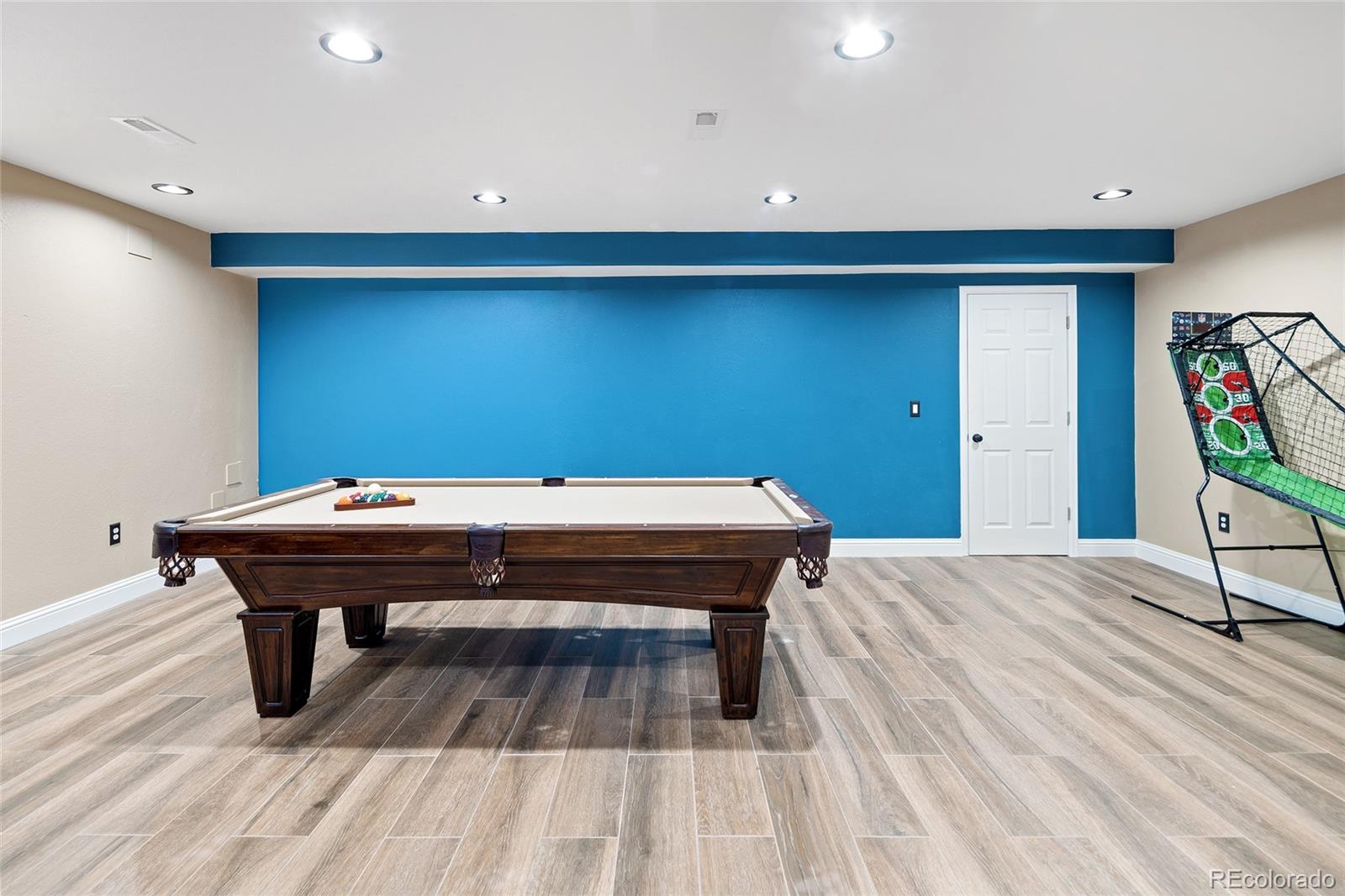 10269 Fawnbrook Court Highlands Ranch, CO 80130 - Photo 30 of 45 a room with a table and wooden floor