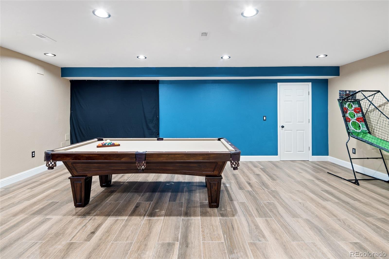 10269 Fawnbrook Court Highlands Ranch, CO 80130 - Photo 31 of 45 a room with a table and a wooden floor