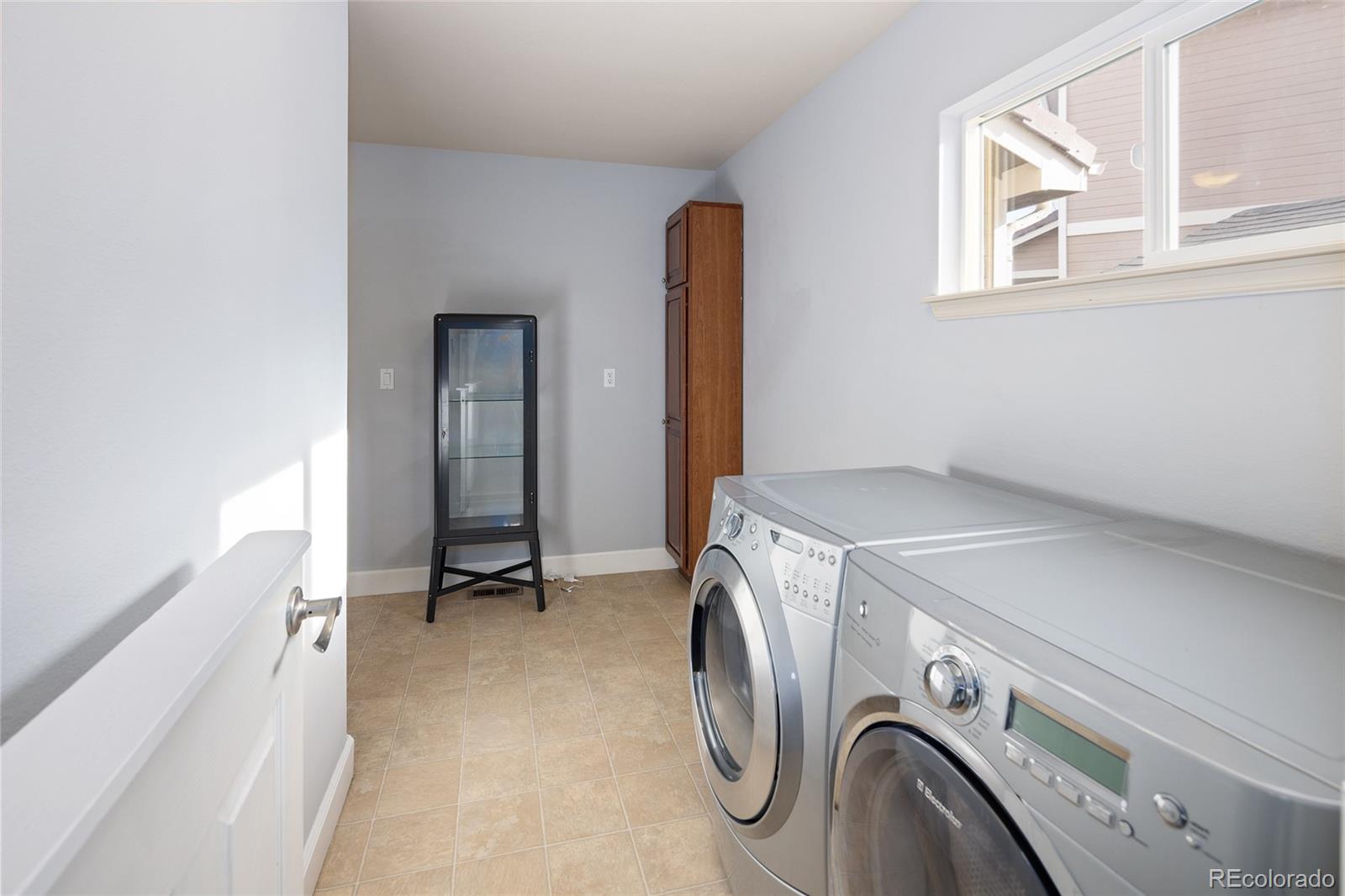 10269 Fawnbrook Court Highlands Ranch, CO 80130 - Photo 34 of 45 a view of storage and utility room with washer and dryer