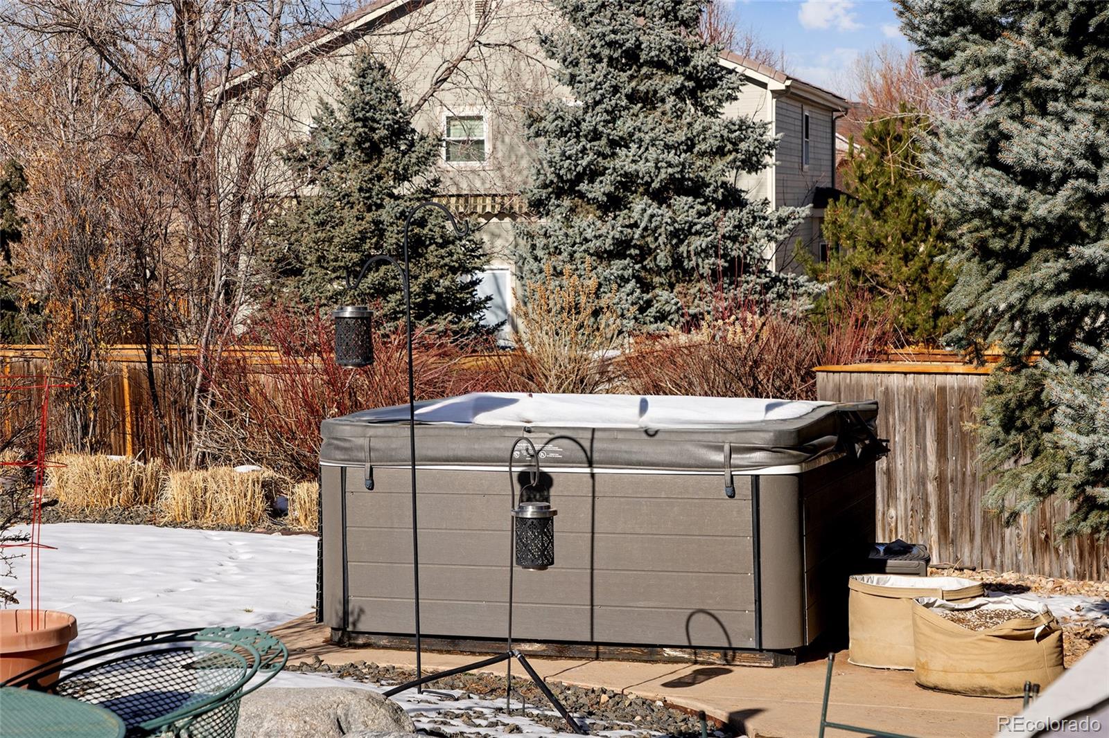 10269 Fawnbrook Court Highlands Ranch, CO 80130 - Photo 38 of 45 a view of a patio with couches and table with chairs and potted plants
