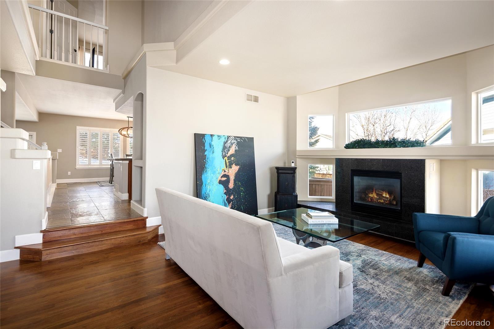 10269 Fawnbrook Court Highlands Ranch, CO 80130 - Photo 8 of 45 a living room with furniture and a fireplace