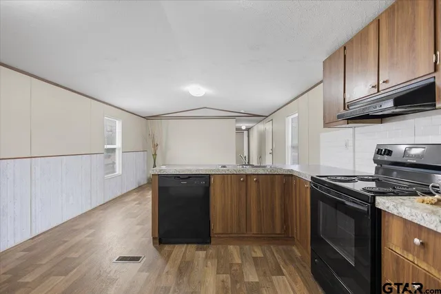 a kitchen with stainless steel appliances granite countertop a stove and a sink