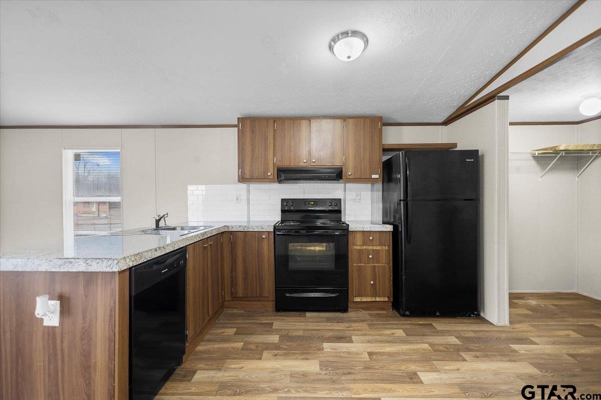 307 St Joseph Street Athens, TX 75751 - Photo 6 of 24 a kitchen with granite countertop a refrigerator stove and sink