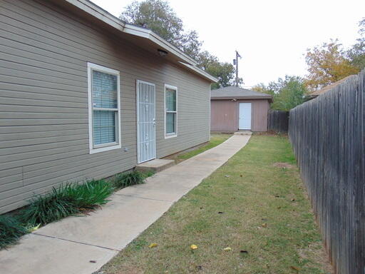 1712 23rd Street, Unit B Lubbock, TX 79411 - Photo 2 of 9 a front view of a house with garden