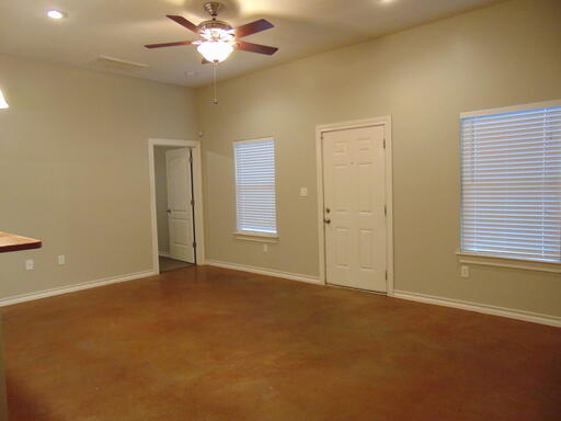1712 23rd Street, Unit B Lubbock, TX 79411 - Photo 3 of 9 an empty room with closet and a chandelier fan