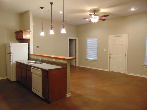 1712 23rd Street, Unit B Lubbock, TX 79411 - Photo 4 of 9 a kitchen with a stove and a ceiling fan