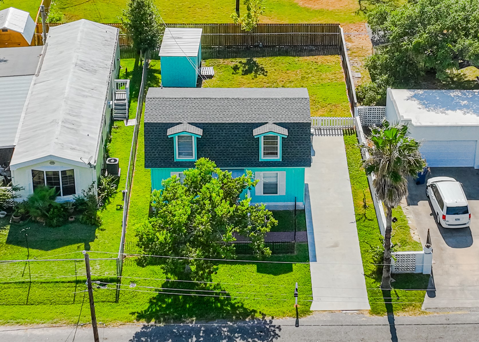 a aerial view of a house with garden space and a swimming pool