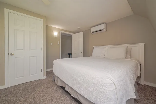 a bedroom with a bed and a night stand