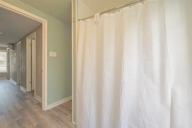 a view of a bathroom with a shower curtain