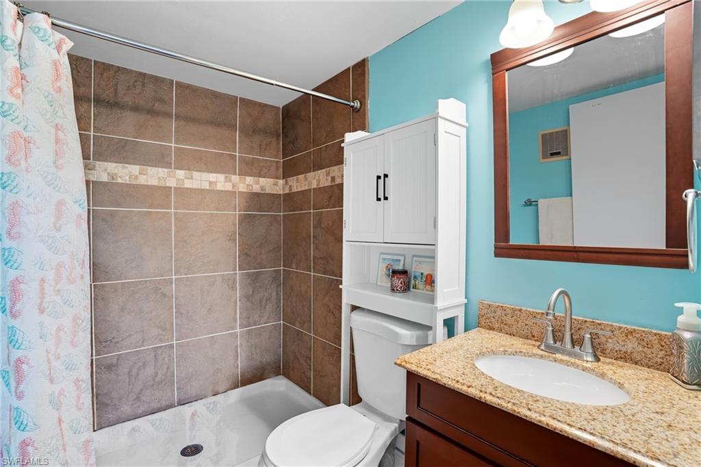 4790 South Cleveland Avenue, Unit 907 Fort Myers, FL 33907 - Photo 14 of 24 Primary bathroom featuring a walk-in shower stall, beautiful tile and vanity