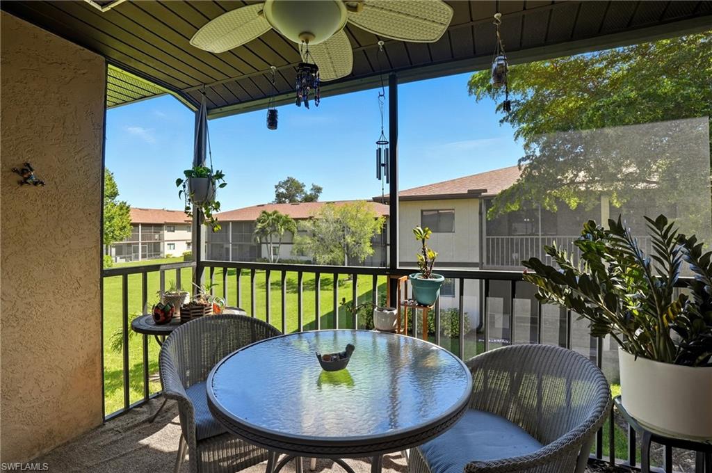 4790 South Cleveland Avenue, Unit 907 Fort Myers, FL 33907 - Photo 19 of 24 Screened balcony featuring a ceiling fan, and outdoor dining space